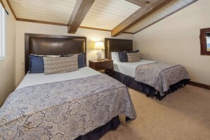 A room with two beds, each with a headboard and a bedside table. - The Lodge at Vail, a RockResort by Vail Resorts (Vail)