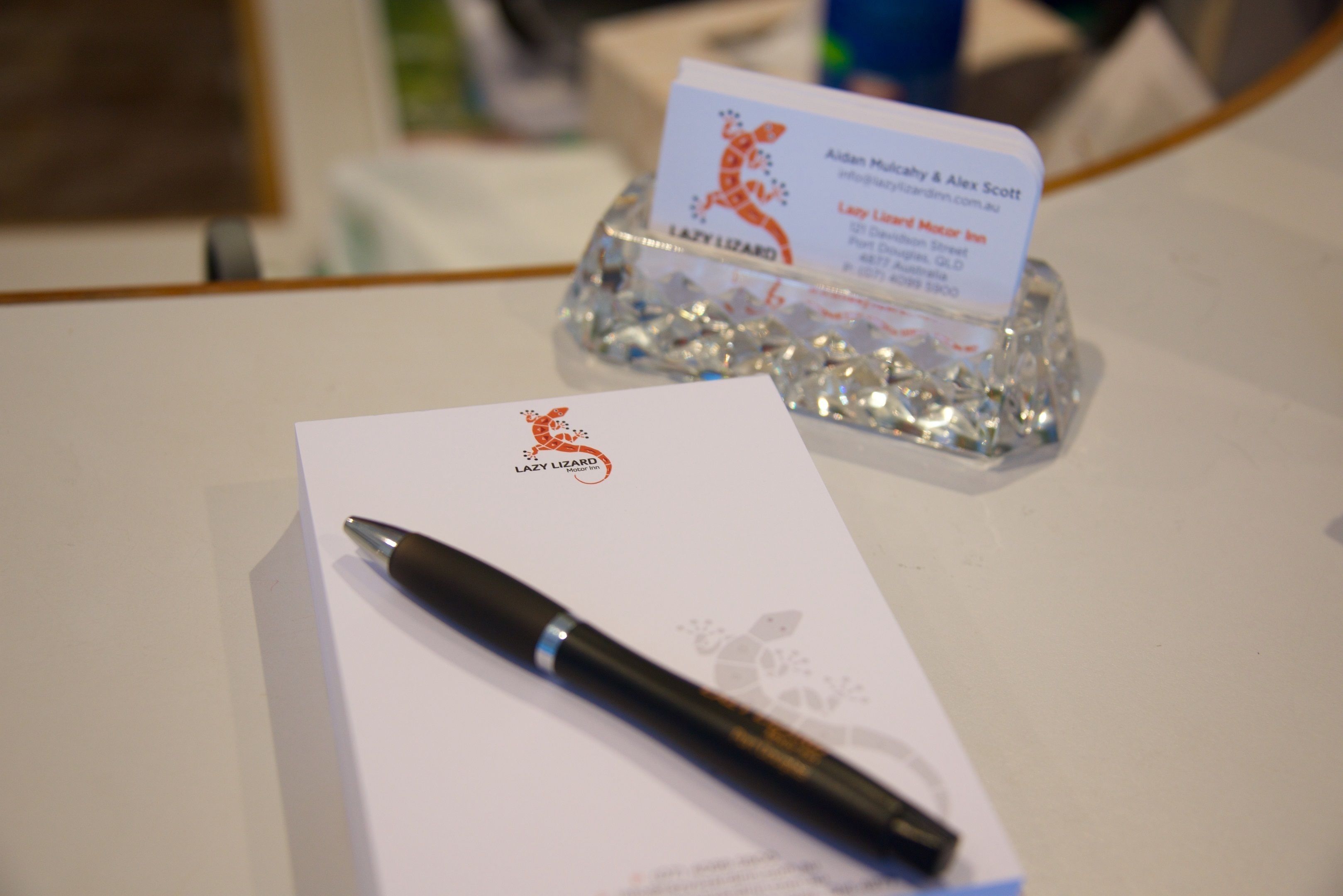 A business card and a pen on a table.