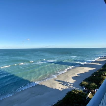 On the beach, white sand, beach cabanas, beach towels