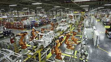 A large industrial facility with multiple robotic arms and assembly lines.