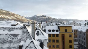 A snow-covered mountain in the background with buildings in the foreground. - Scandic Bergen City (Bergen)