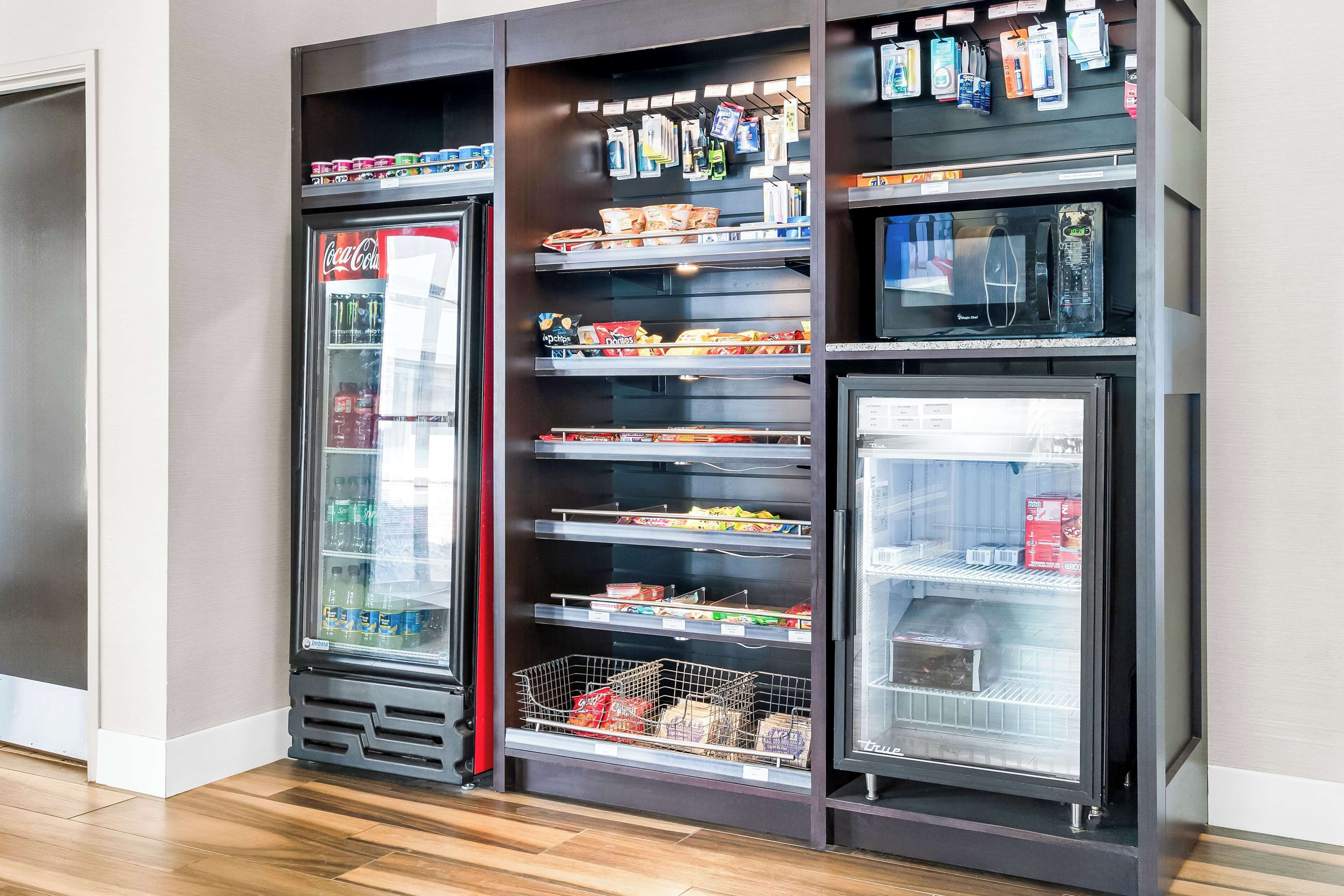 A vending machine with snacks and beverages, including Coca-Cola.