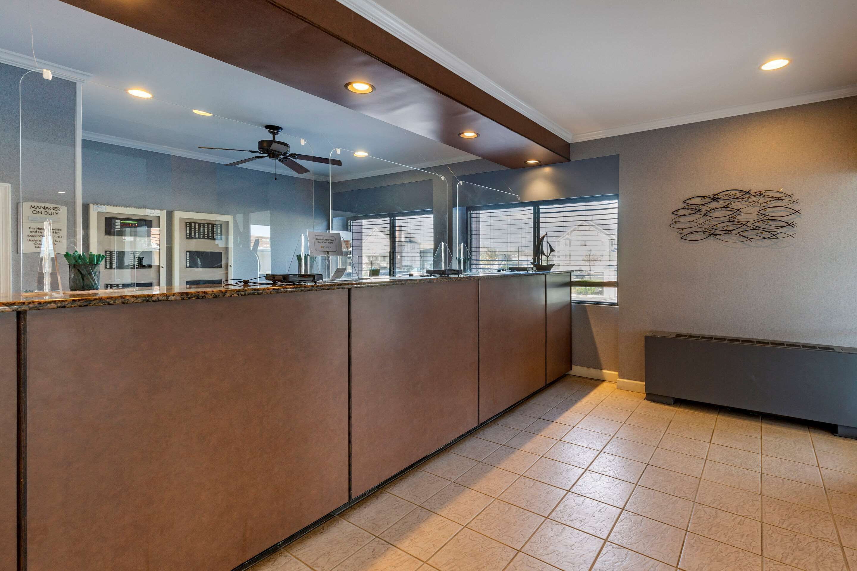 A modern kitchen with a central island, built-in appliances, and a ceiling fan.