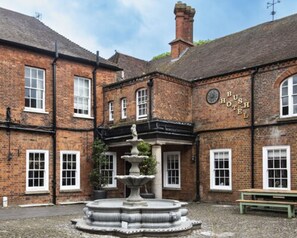 A traditional brick building with a sign reading "BUSH HOTEL". - Bush Hotel Farnham (Farnham)