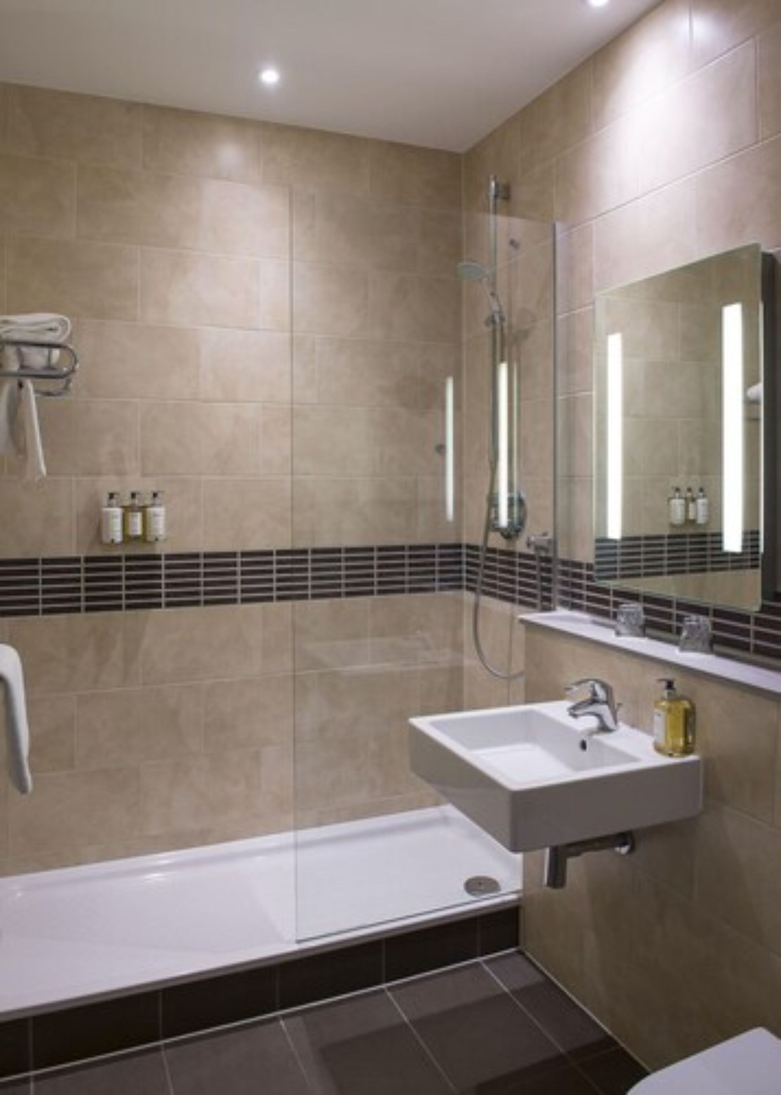 A modern bathroom with a bathtub, a sink, and a shower.