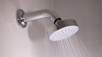 A modern showerhead with water flowing from it.