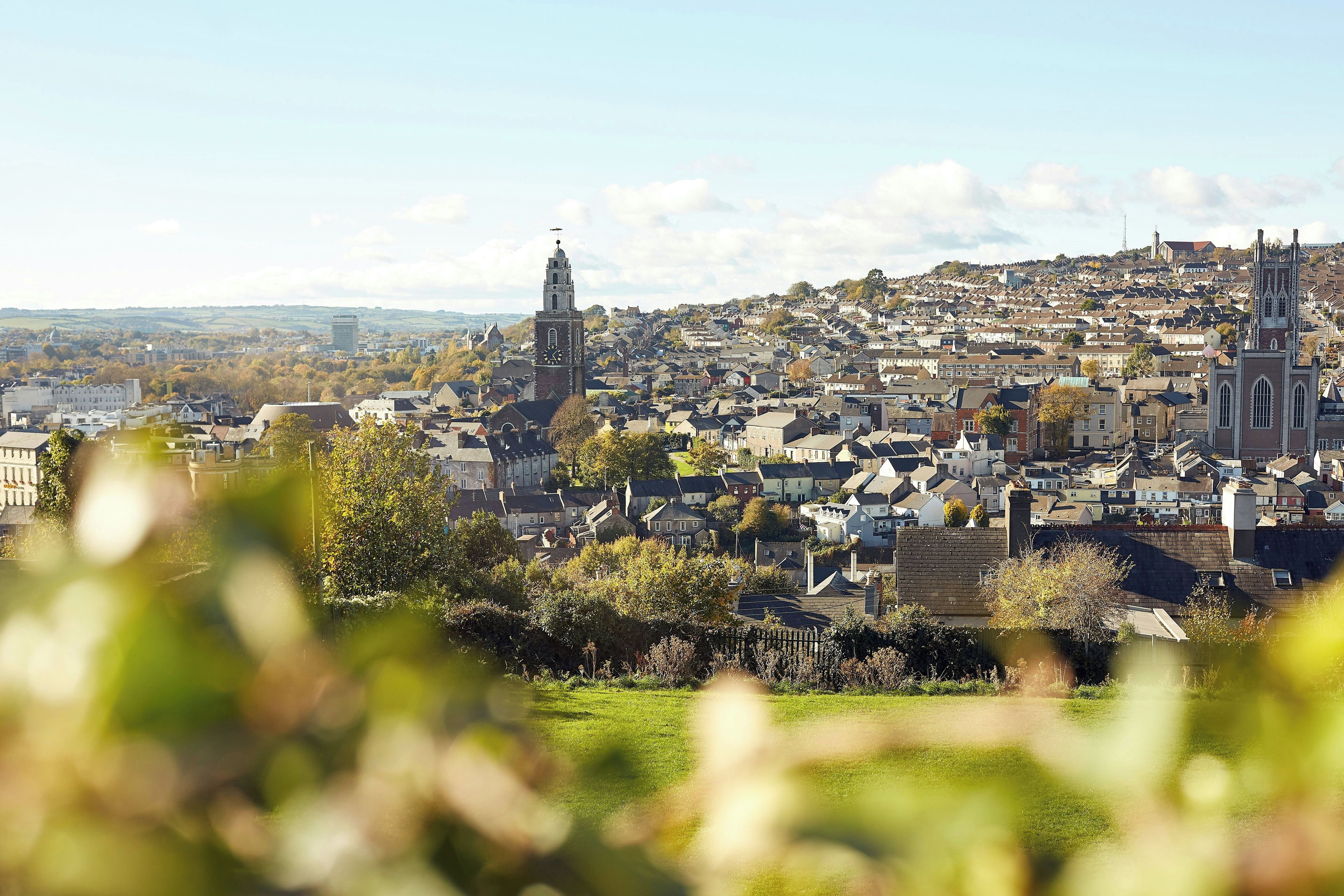 A cityscape with a prominent church tower and residential buildings.