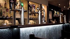 A bar area with multiple beer taps and a counter. - Leonardo Hotel Cork (Cork)