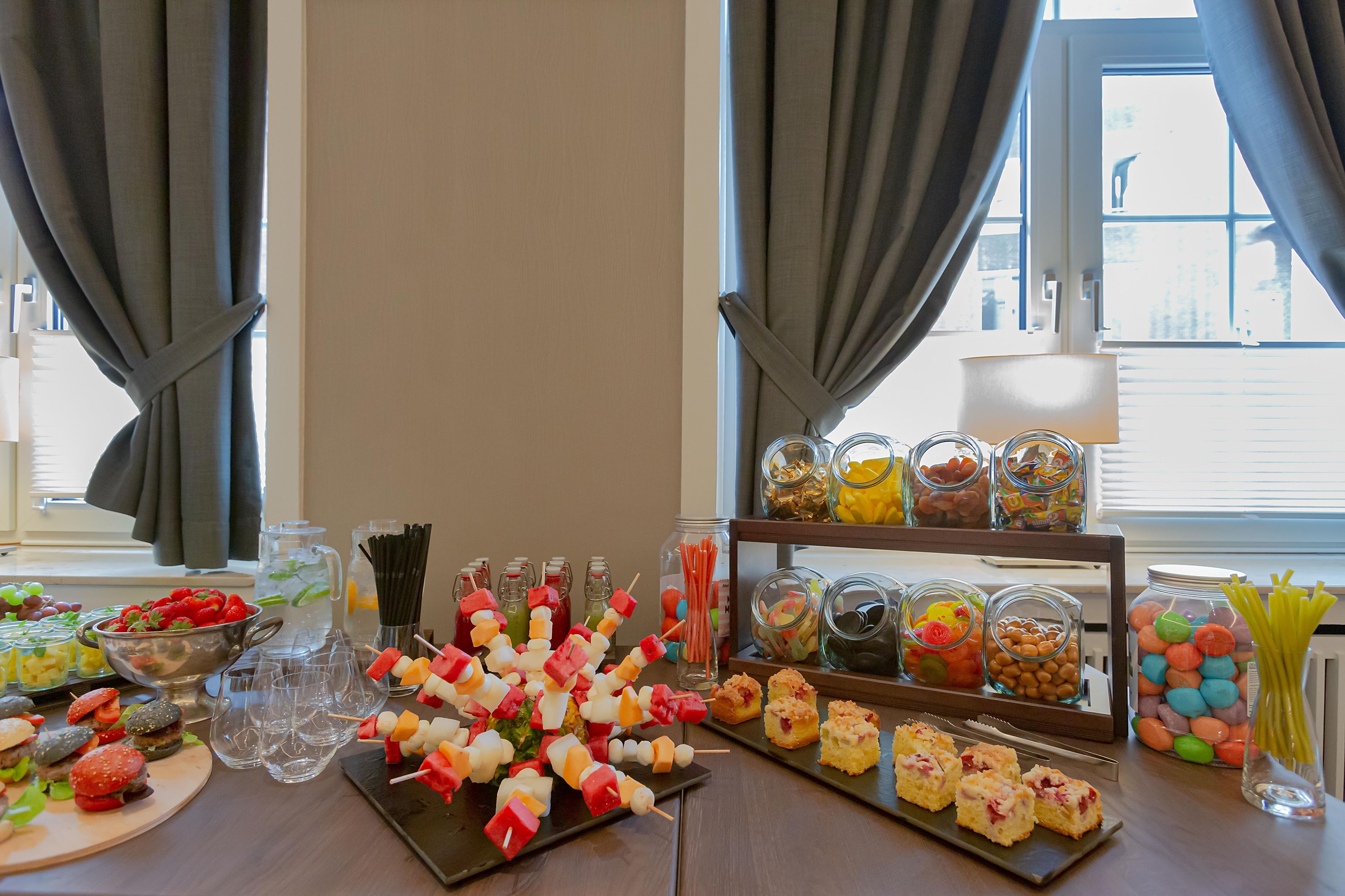 A buffet table with various food items and beverages.
