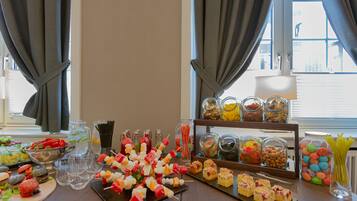 A buffet table with various food items and beverages.