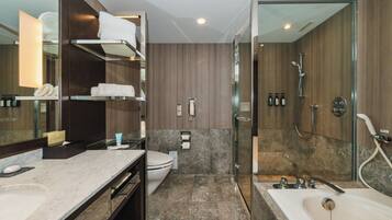 A modern bathroom with a marble sink, a glass-enclosed shower, and a toilet.