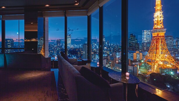 A modern hotel room with large windows offering a view of the Eiffel Tower at night. - The Prince Park Tower Tokyo - Preferred Hotels & Resorts, LVX Collection (Tokyo)