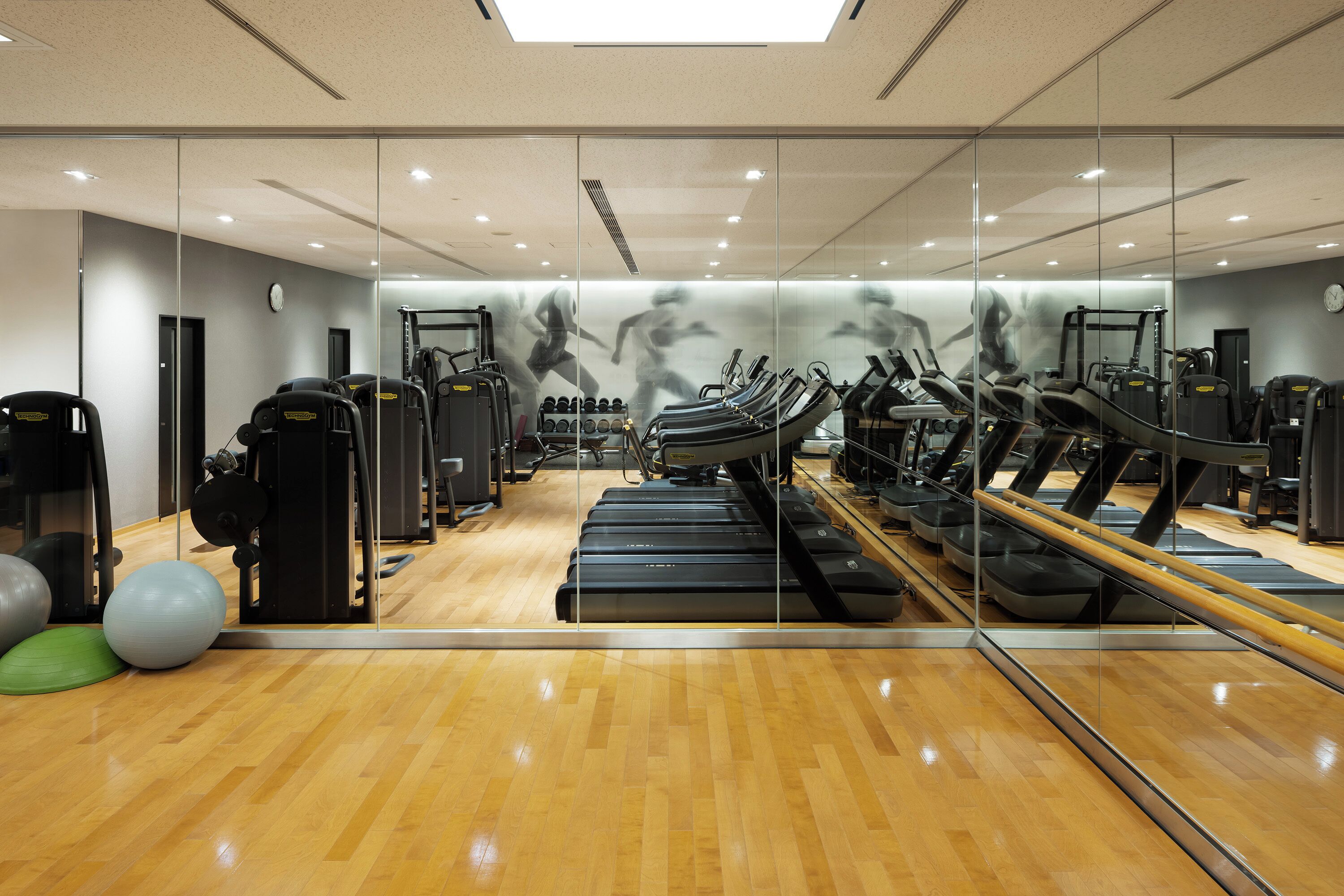 A gym with treadmills, exercise balls, and weight machines.