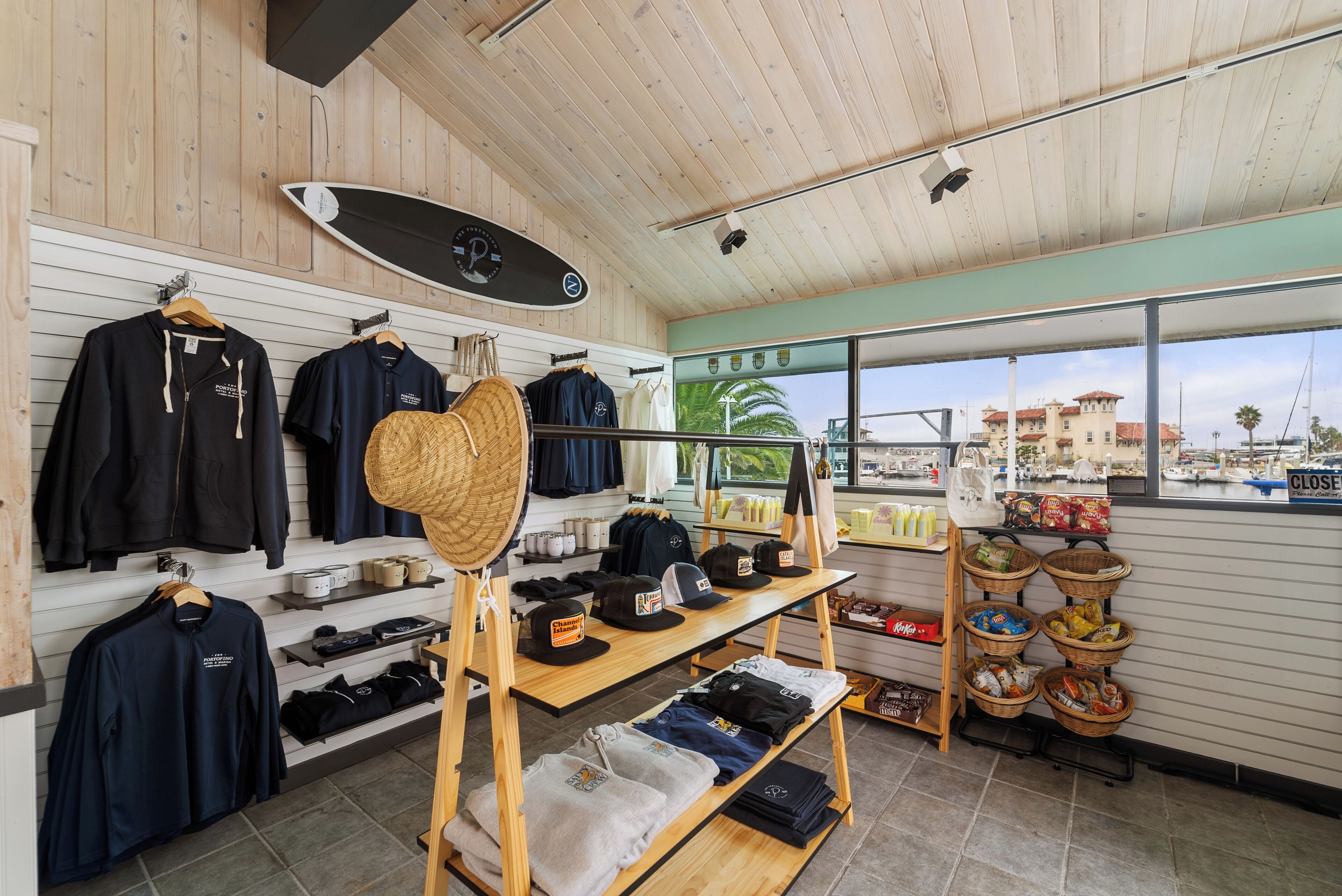 A store with wooden walls, shelves with clothing, hats, and accessories.