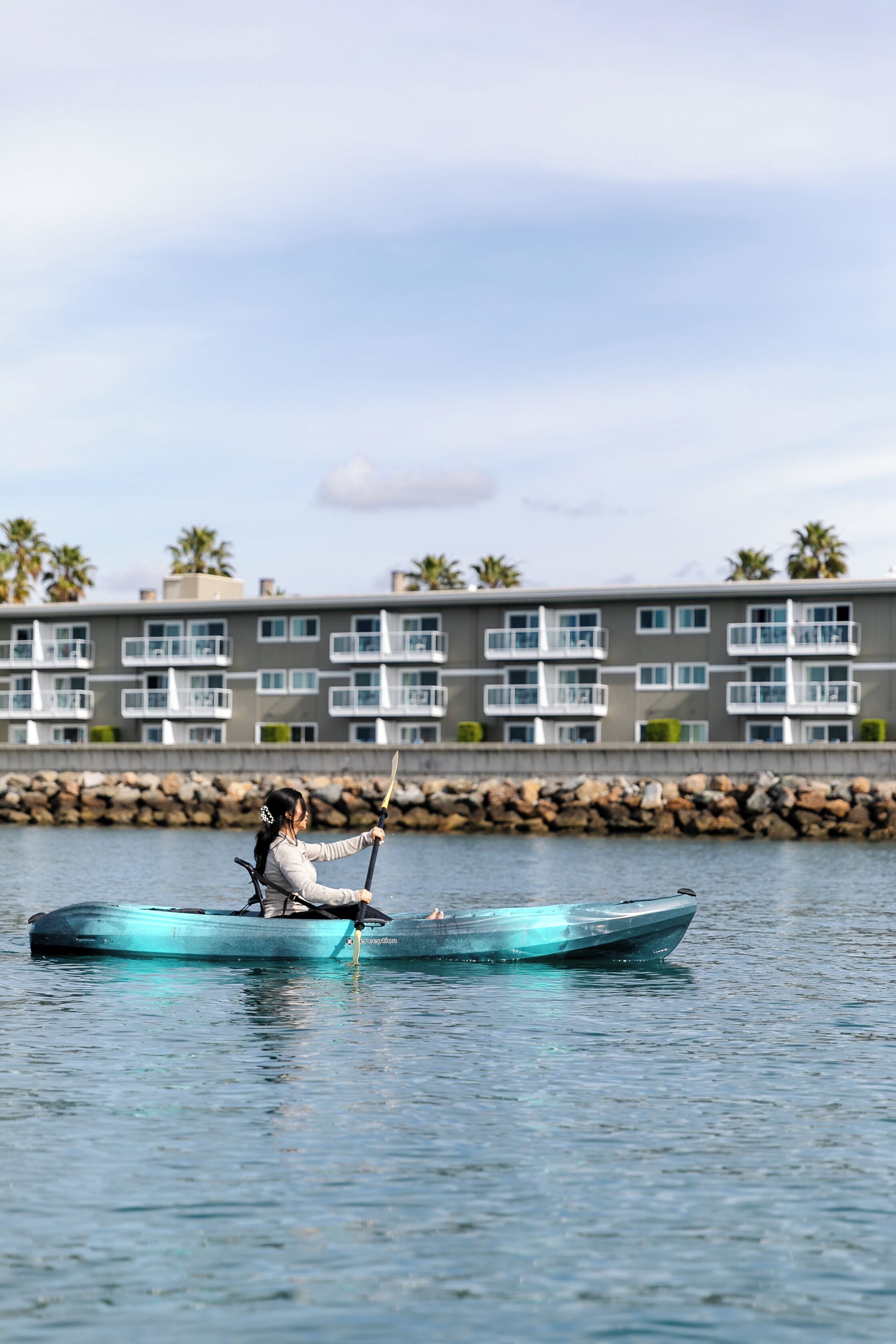 A boat on calm water with a building in the background.