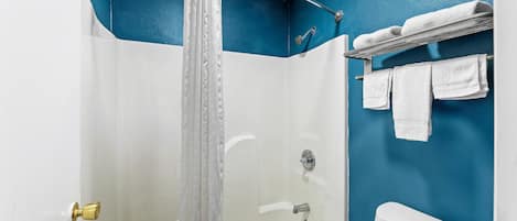 A bathroom with a shower, a bathtub, and a toilet.