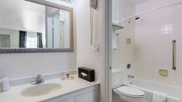 A bathroom with a sink, mirror, and toilet.