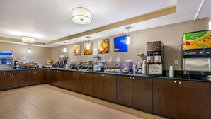 A breakfast bar with a coffee machine, tea station, and various food options. - Comfort Inn & Suites St. Pete - Clearwater International Airport (Clearwater)