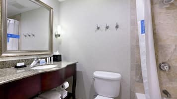 A bathroom with a sink, toilet, and shower.
