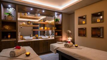 Experience serene relaxation in this spa room with two treatment areas, a large mirror, and soothing ambiance.