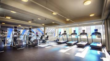A gym with treadmills, elliptical machines, and stationary bikes.