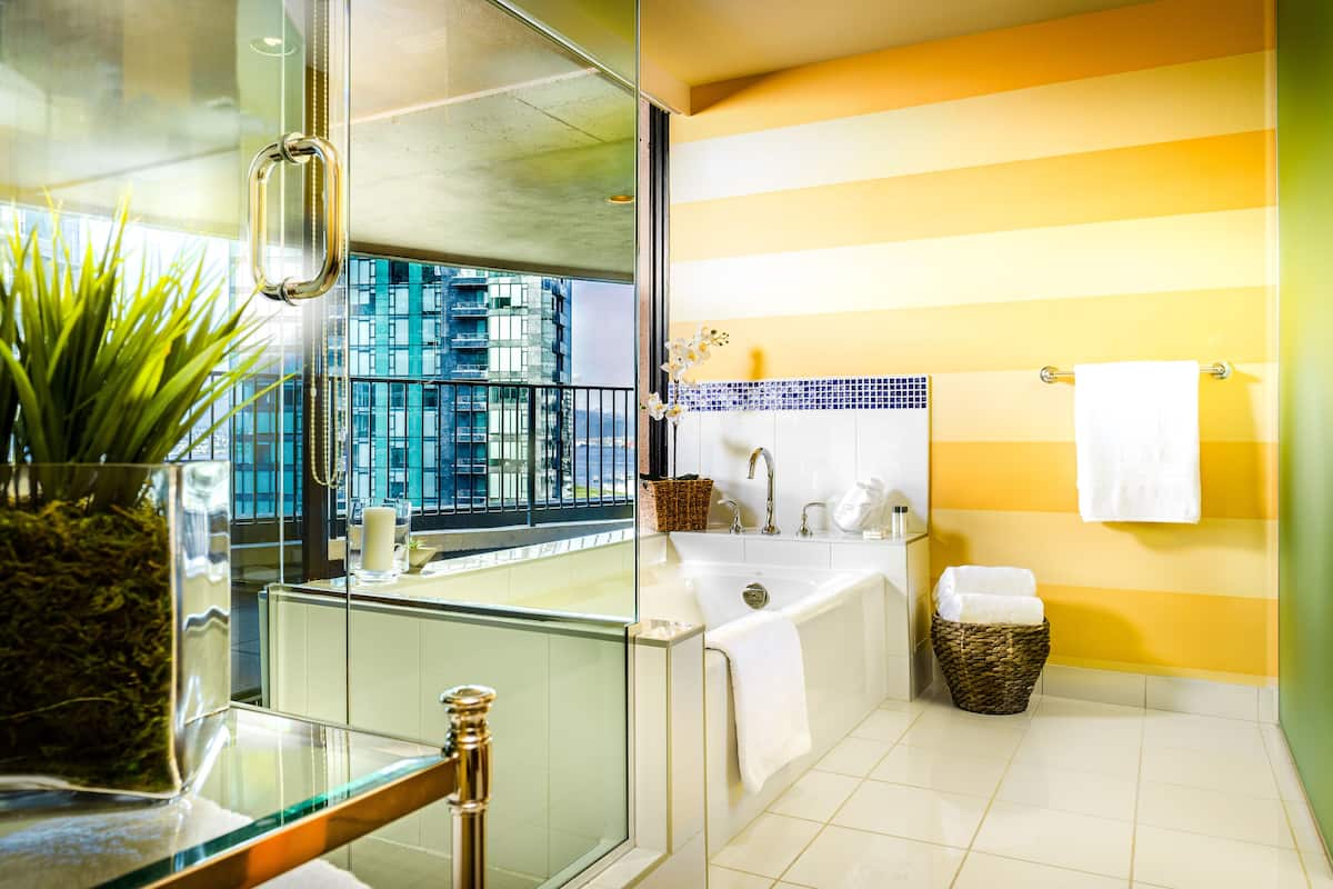 suite (coal harbour) | bathroom | combined shower/bathtub, designer toiletries, hair dryer, towels
