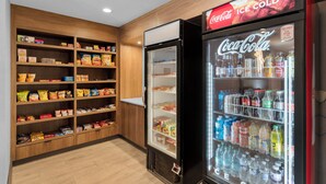 A vending area with snacks and Coca-Cola refrigerators. - Holiday Inn Dubuque/Galena by IHG (Dubuque)