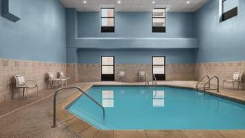 Relax by the rectangular pool surrounded by a tiled deck and seating areas.