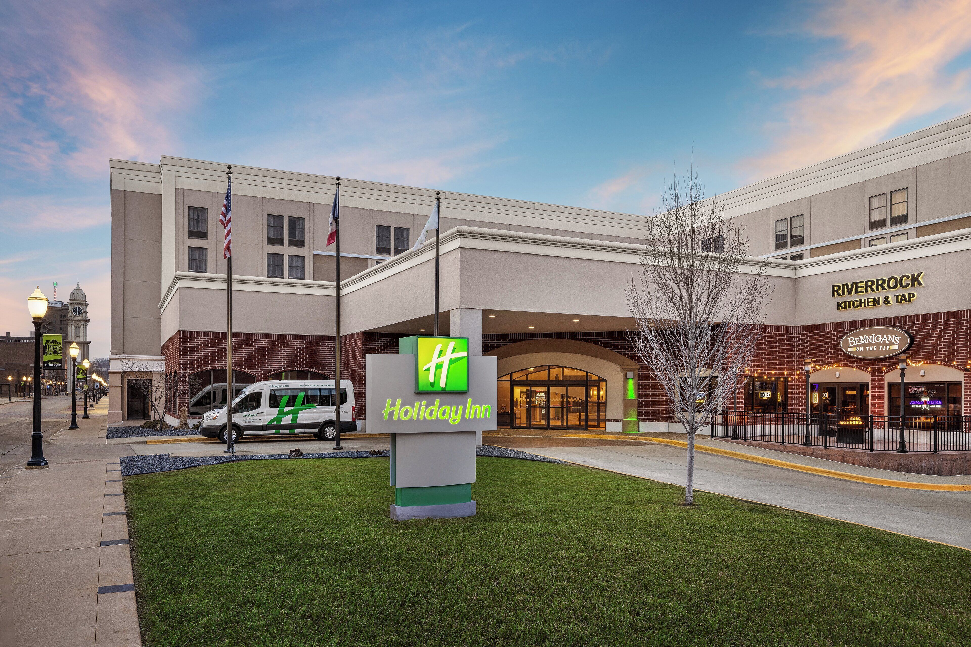 A Holiday Inn Express hotel with a brick facade, a Holiday Inn sign, and a Holiday Inn Express sign.