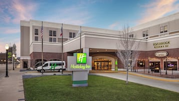 A Holiday Inn Express hotel with a brick facade, a Holiday Inn sign, and a Holiday Inn Express sign.
