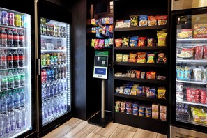 A vending machine area with various snacks and drinks.