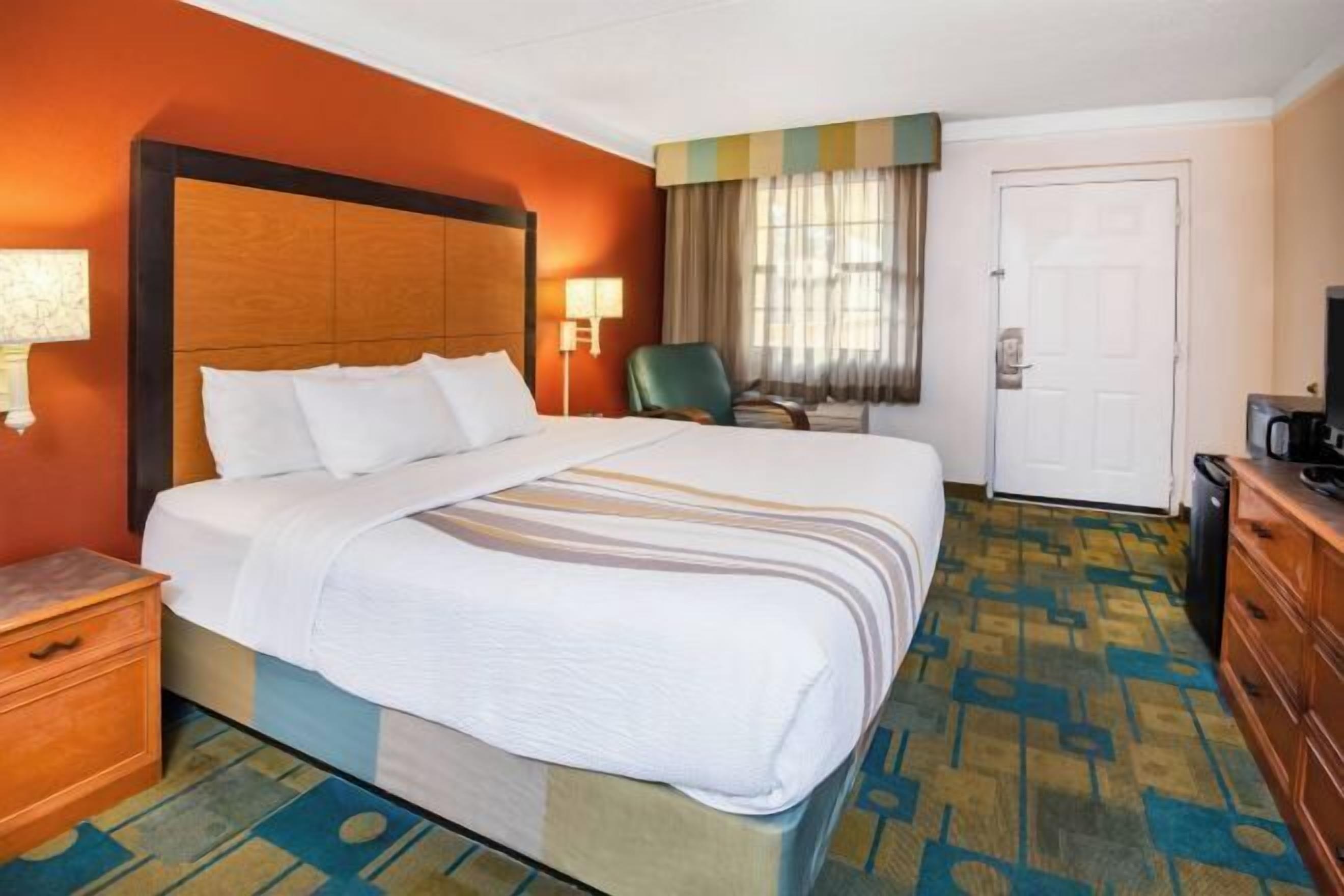 Premium bedding, desk, laptop workspace, blackout curtains