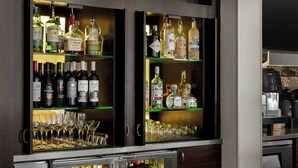A bar area with shelves stocked with various liquor bottles and glasses. - Courtyard by Marriott Santa Rosa (Santa Rosa)