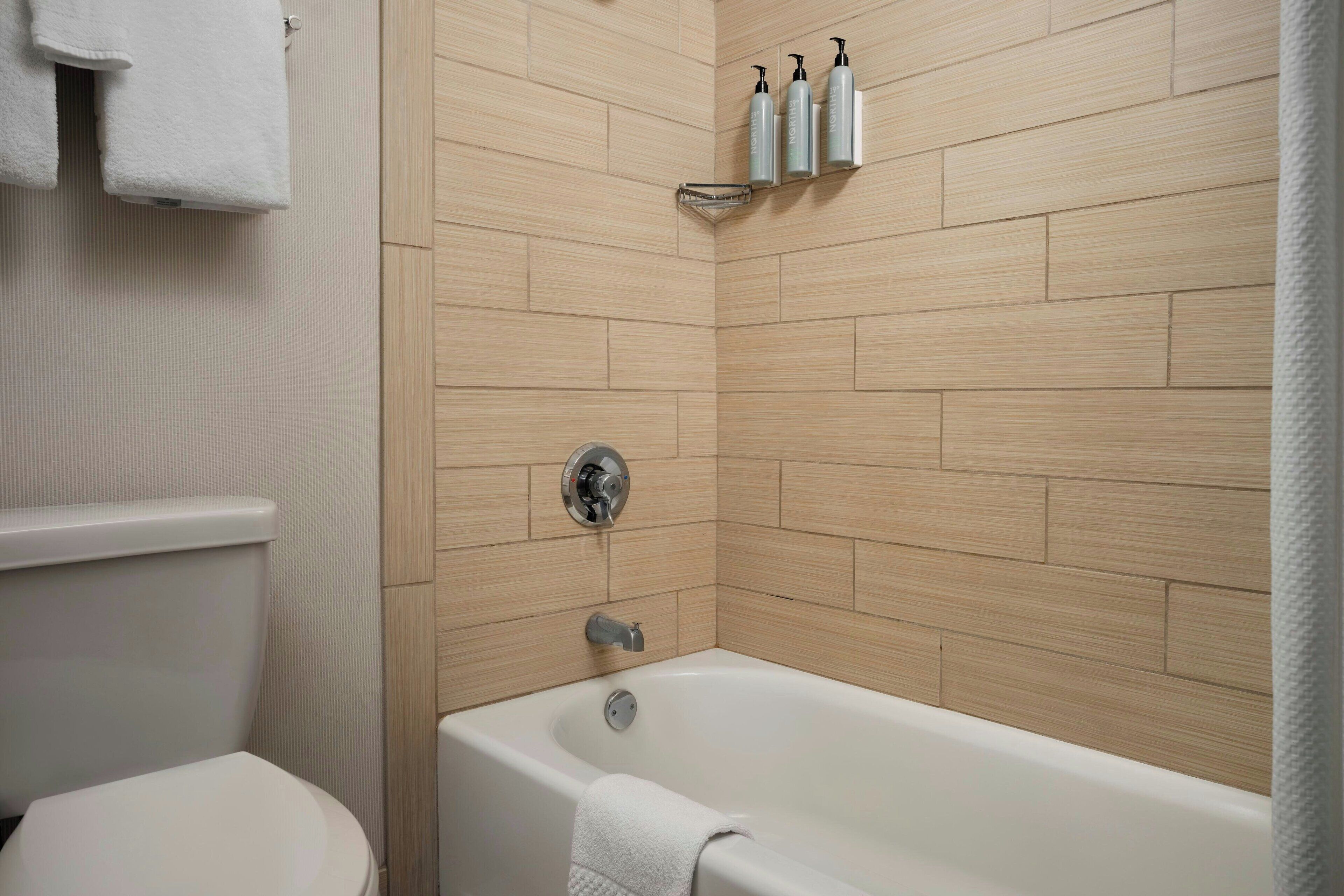 room, 2 queen beds | bathroom | combined shower/bathtub, free toiletries, hair dryer, towels