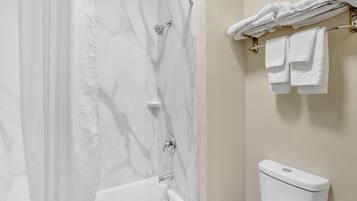 A bathroom with a bathtub, a shower, and a toilet.