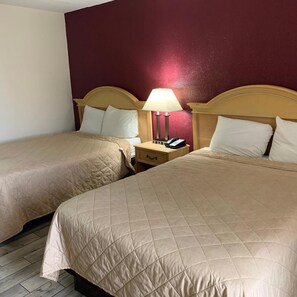 A hotel room with two beds, a nightstand with a lamp, and a telephone. - Super Inn (Mobile)