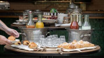 A breakfast buffet with various food items and beverages.