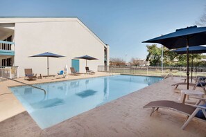 Seasonal outdoor pool, open 10:00 AM to 10:00 PM, pool loungers