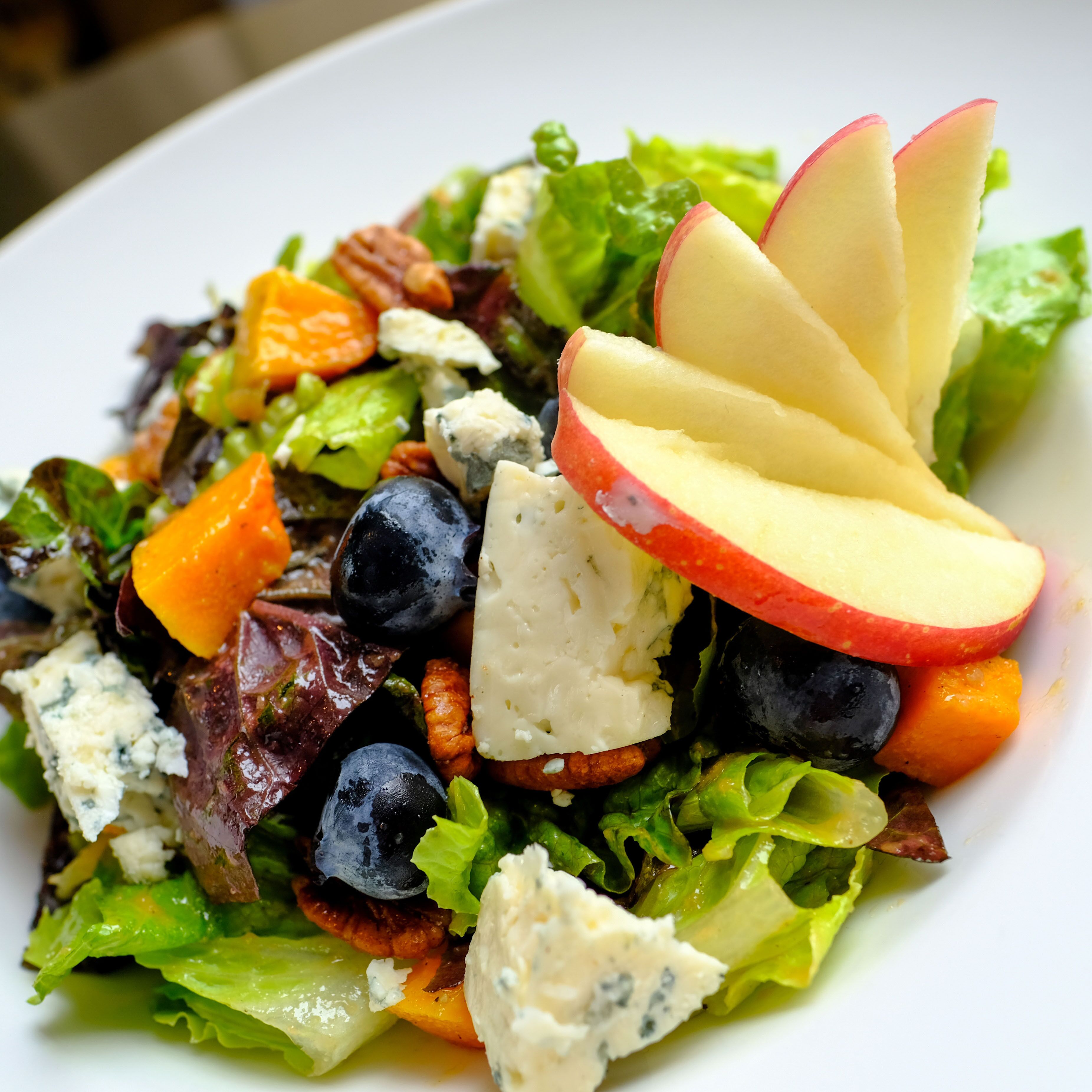 A salad with various vegetables and cheese.