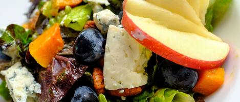 A salad with various vegetables and cheese.