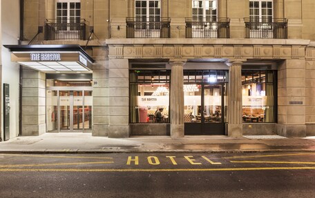 A hotel entrance with a sign reading "The Bristol Hotel."