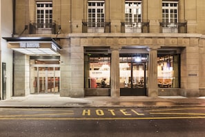 A hotel entrance with a sign reading "The Bristol Hotel."