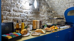 A breakfast buffet with various food items and condiments. - Trianon Gare de Lyon (Paris)