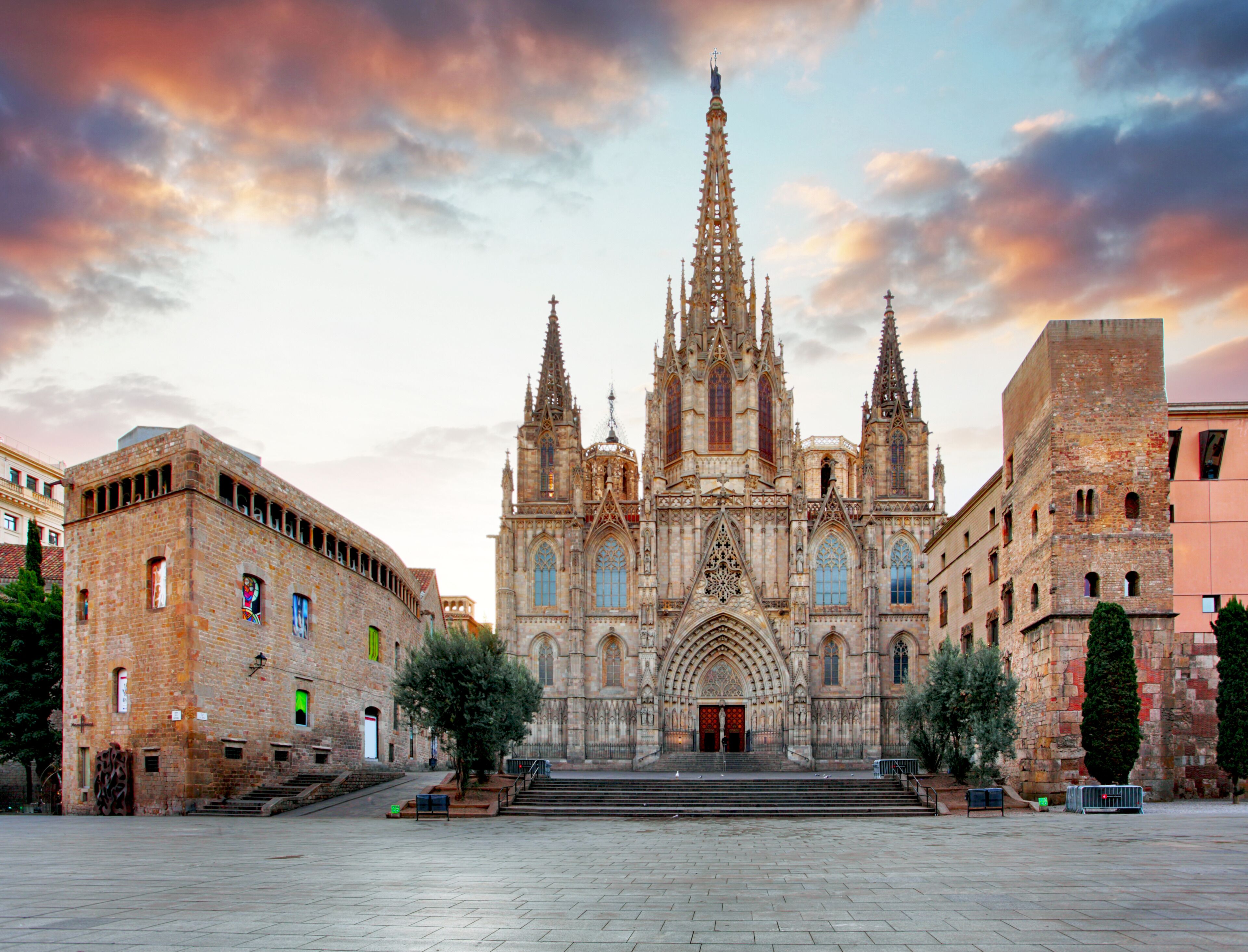 A historic cathedral with a central spire, large arched windows, and a symmetrical facade.