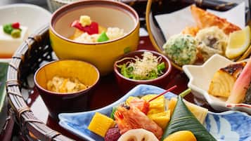 A variety of dishes on a tray, including seafood, vegetables, and rice.