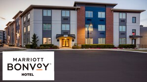 A multi-story Marriott Bonvoy hotel with a modern architectural design, featuring a mix of brick and glass facades, and a well-maintained exterior with landscaped gardens. - City Express By Marriott King of Prussia (King of Prussia)