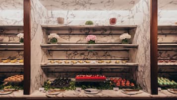 A marble display case with various food items and decorative elements.
