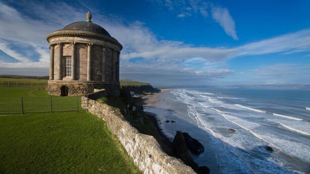 A historic stone building with a dome, located by a coastal cliff overlooking the ocean. - Roe Valley Resort (Limavady)