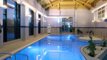 Una piscina cubierta, tumbonas