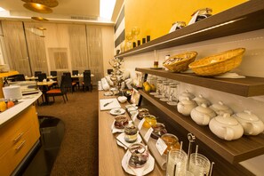 Enjoy a diverse selection of food and drink options at our buffet, featuring multiple serving stations and convenient seating.